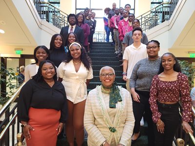 Dr. .Adams-Gaston with student tutors on a staircase in the Wilder Center.