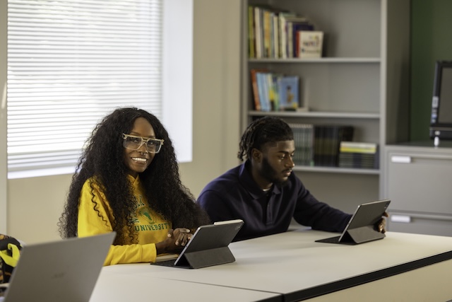 two NSU students using an iPad