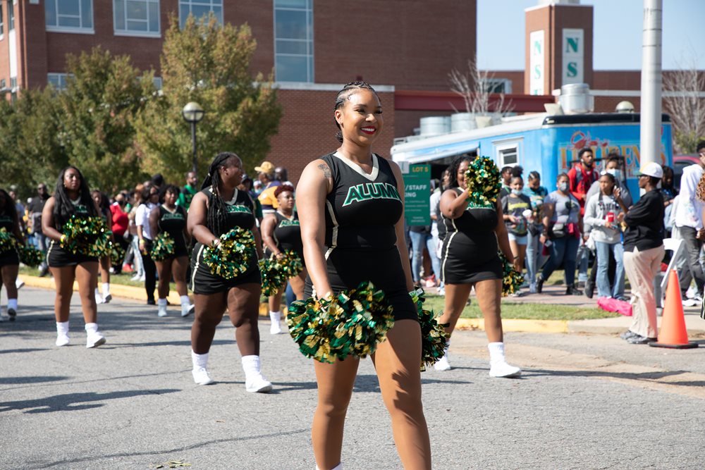 alumni cheerleaders walking on presidential parkway in the homecoming mini parade