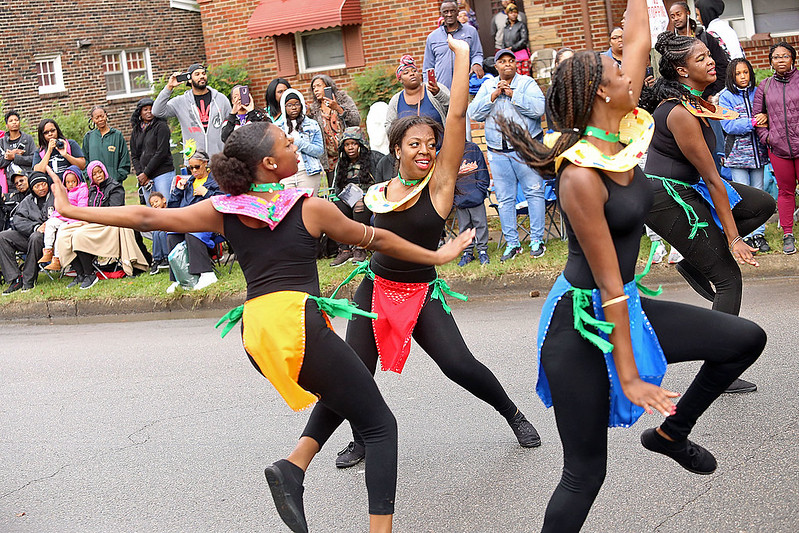 four danceers in black liatar and festive colors