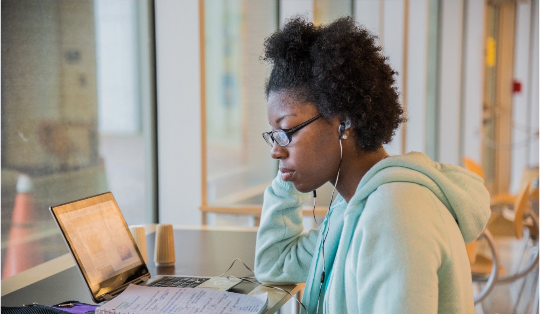 student with computer and led screens