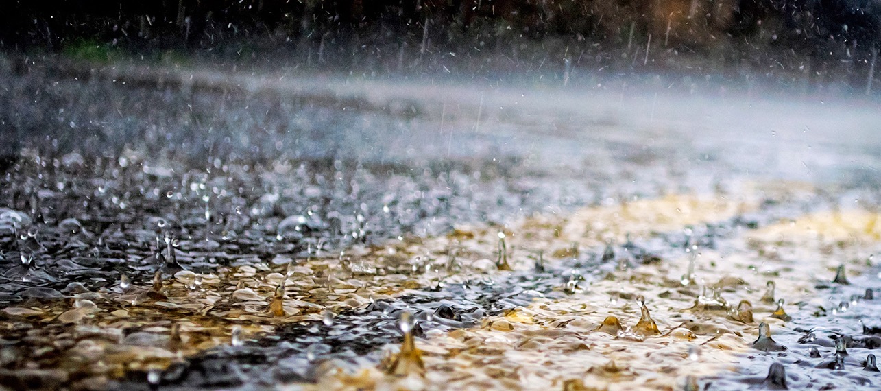 close up image of hard rain on a paved street