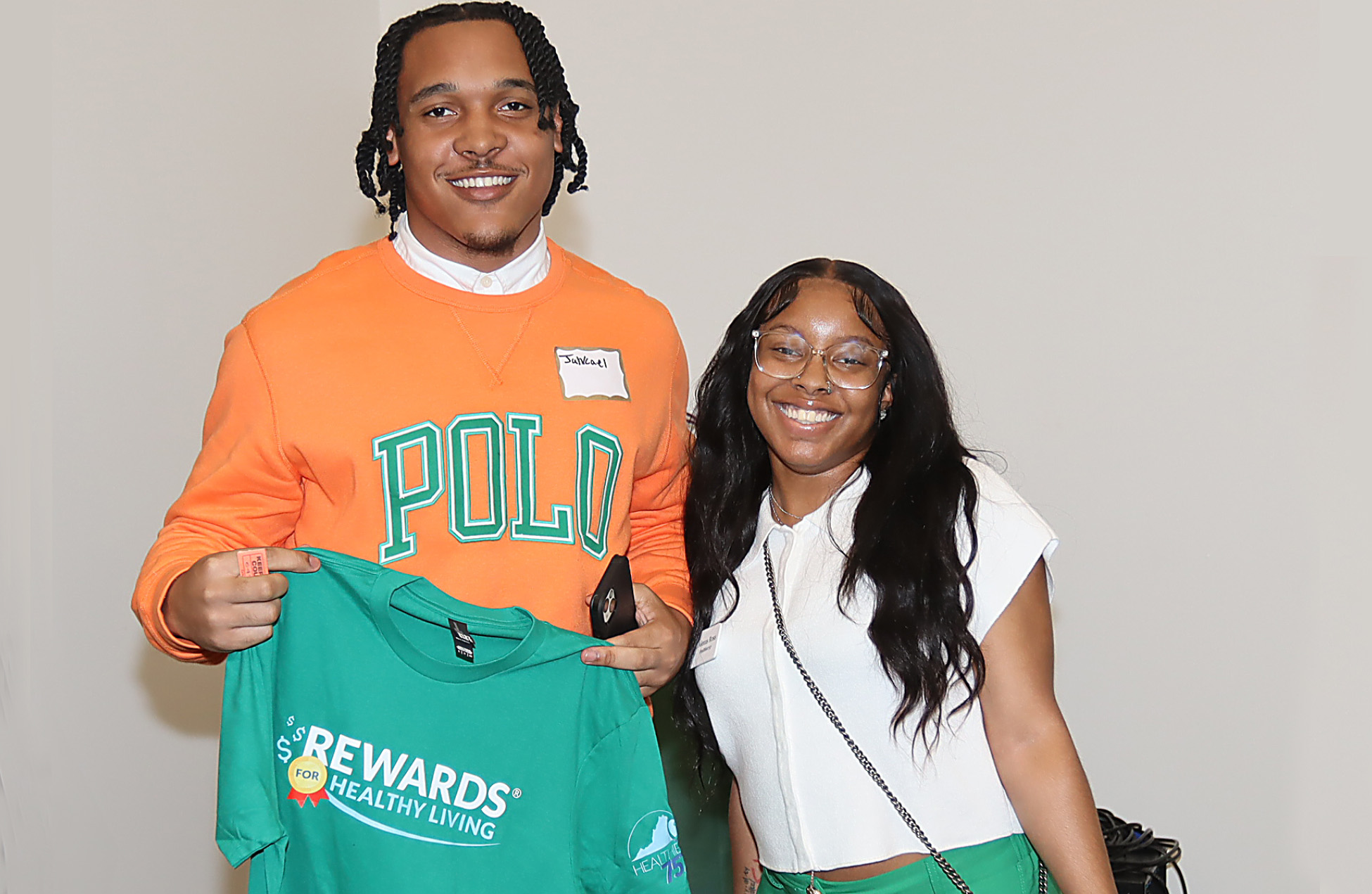 two nsu students holding a healthy spartan t-shirt