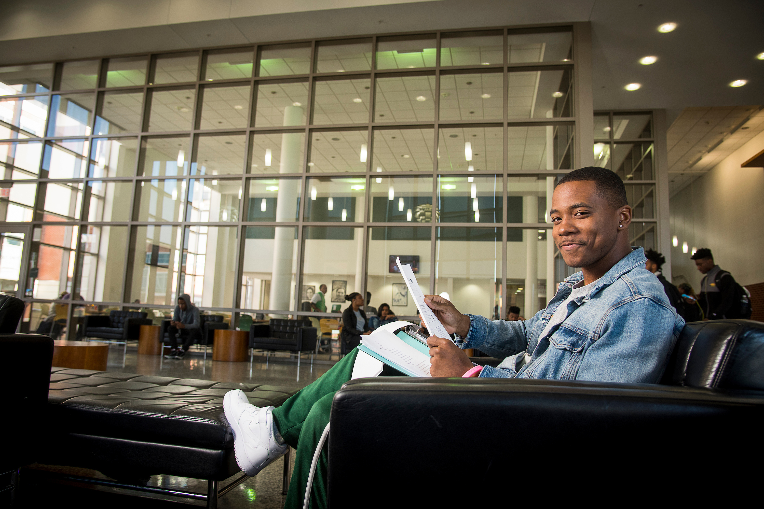 student sitting in the student center reading