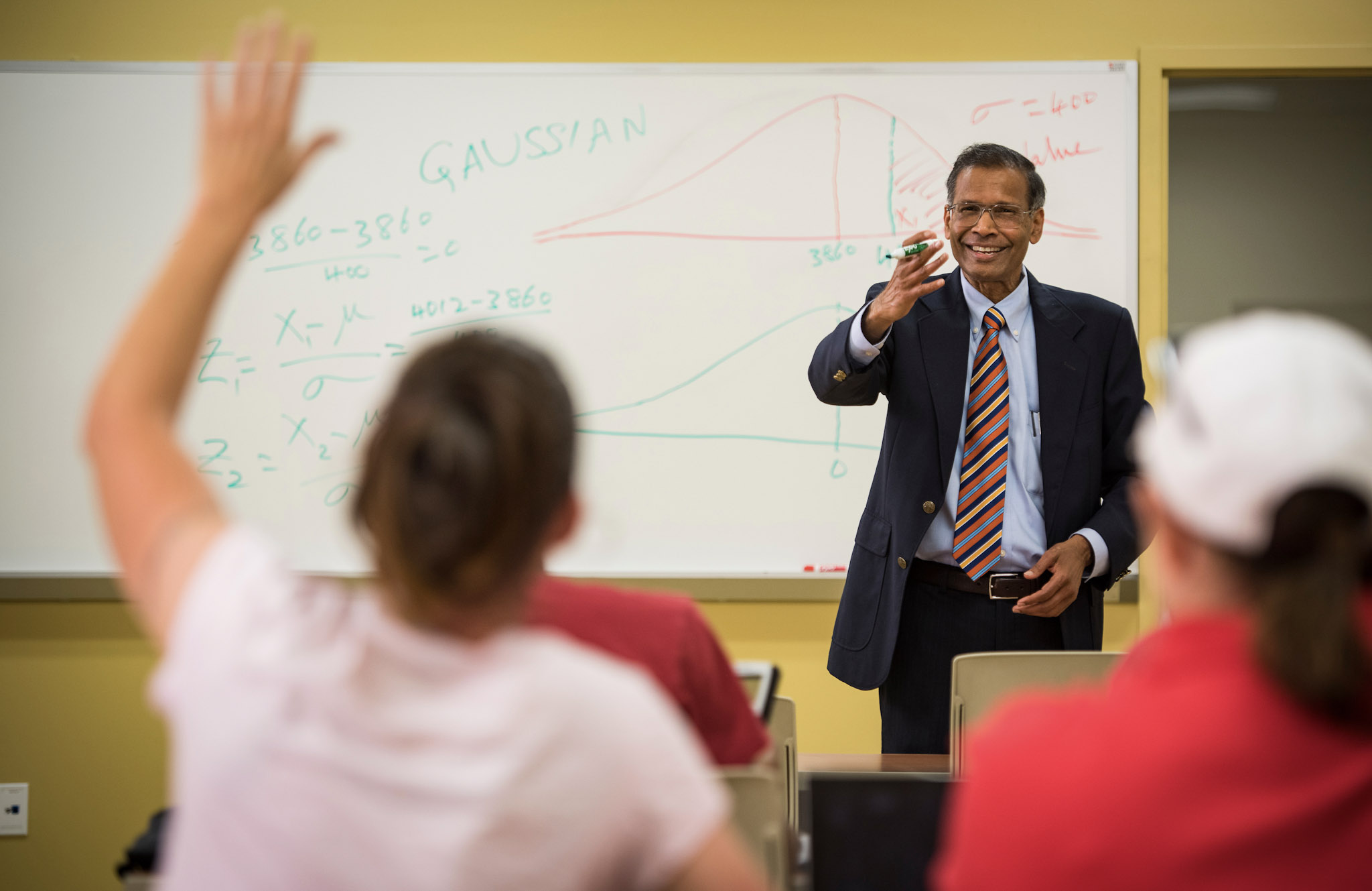 Student raises their hand in class