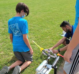 Campers prepare for a rocket launch.