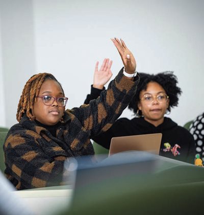 students raising their hands