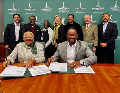 Photo of President, Rector, and BOV at contract signing.