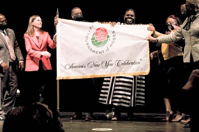 nsu band directors receive the tournament of roses flag