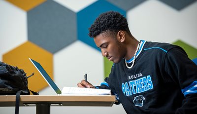 one student studying in front of a laptop
